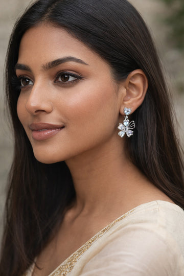 Woman wearing a floral earring with a neutral background