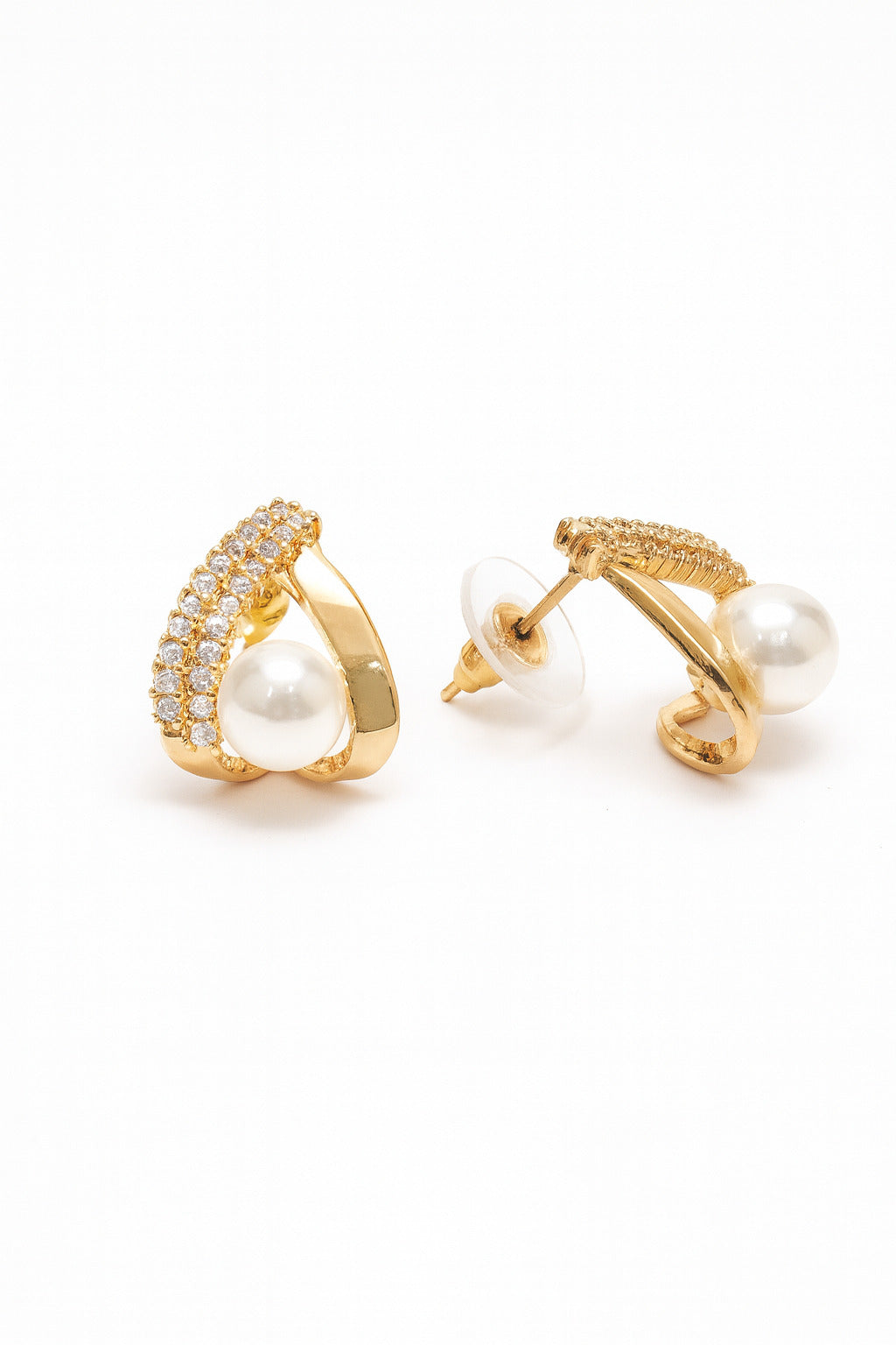Gold earrings with pearls on a white background