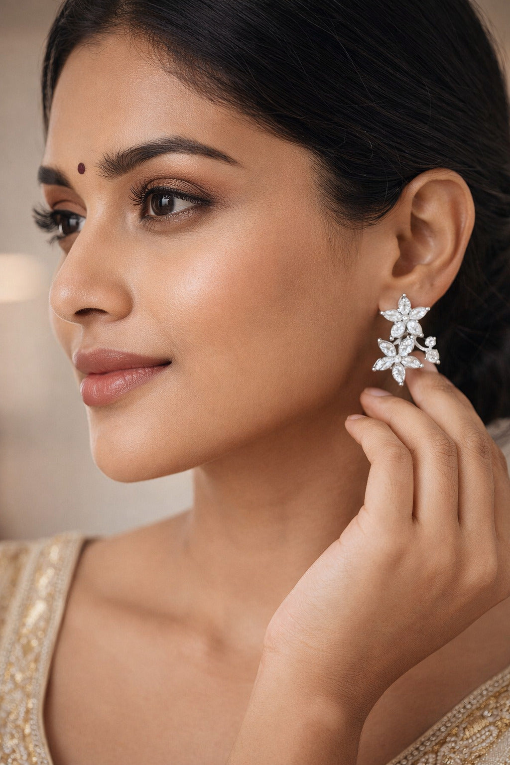 Woman wearing a floral earring, close-up of face and hand