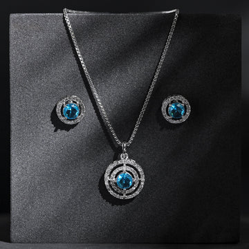 Jewelry set with necklace and earrings featuring blue gemstones on a black background