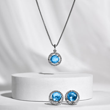 Silver jewelry set with blue gemstones on a white background