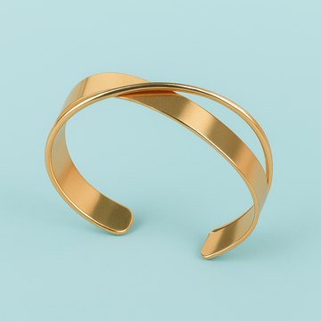 Gold bracelet on a light blue background