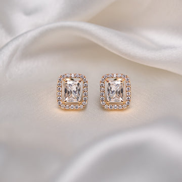 Pair of diamond earrings on a satin surface