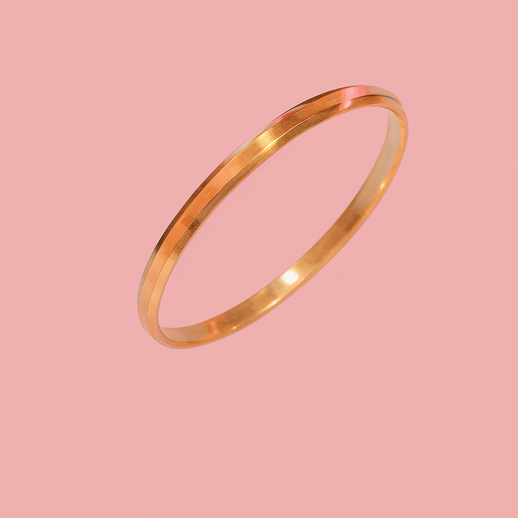 Gold bangle on a pink background