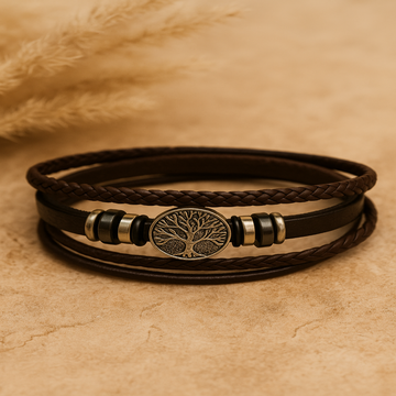 Multilayered leather bracelet with a tree of life emblem on a beige background