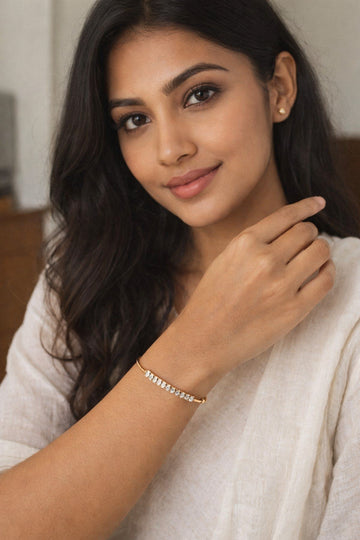 Woman wearing a bracelet with a neutral background