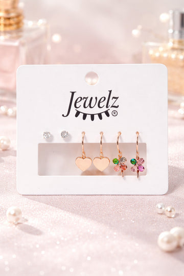 Set of earrings on a 'Jewelz' branded card with decorative lights in the background