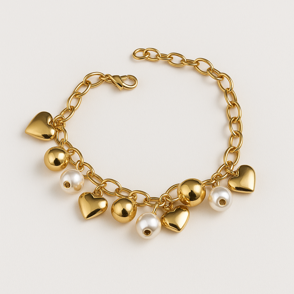 Gold bracelet with heart and pearl charms on a light beige background