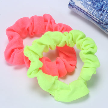 A set of colorful slim rubber bands in pink and green, displayed on a white surface.