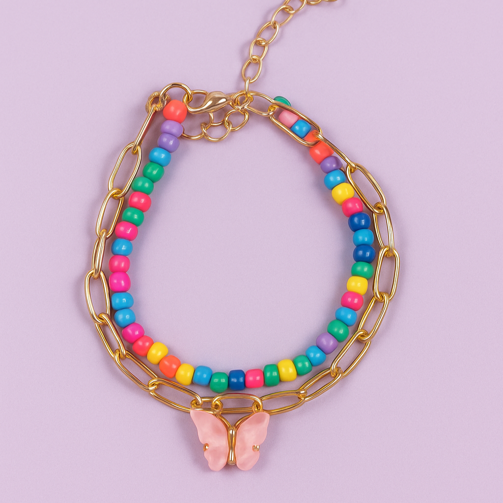 Multicolored beaded bracelet with gold chain and butterfly charm on a light purple background