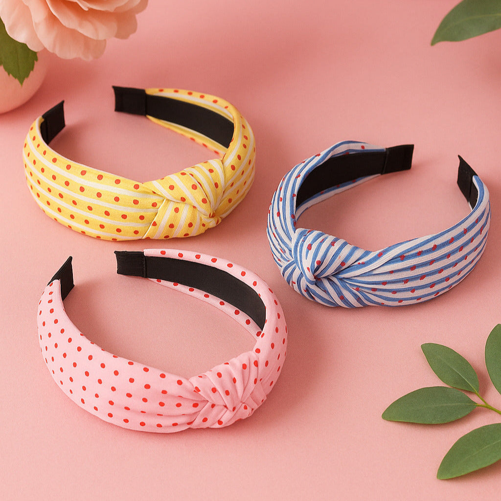 Three colorful headbands on a pink background with floral and leaf elements.
