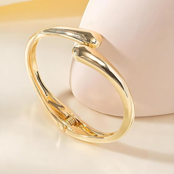 Gold bracelet on a soft beige background