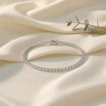 Silver bracelet with clear stones on a beige fabric background