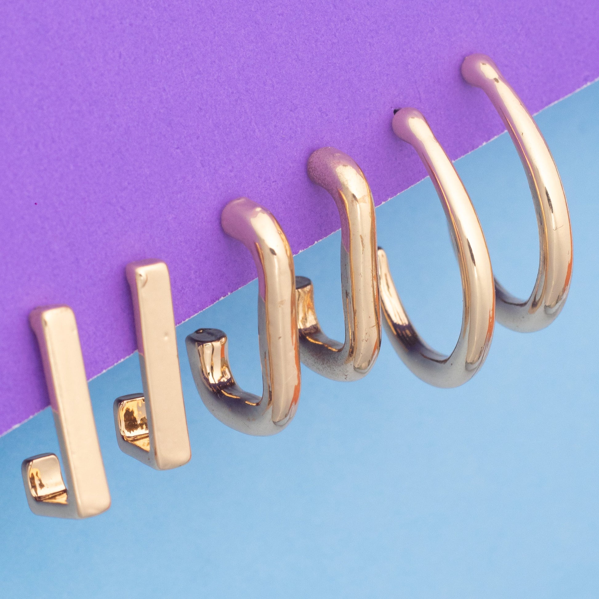 Gold spiral notebook on a two-tone purple and blue background