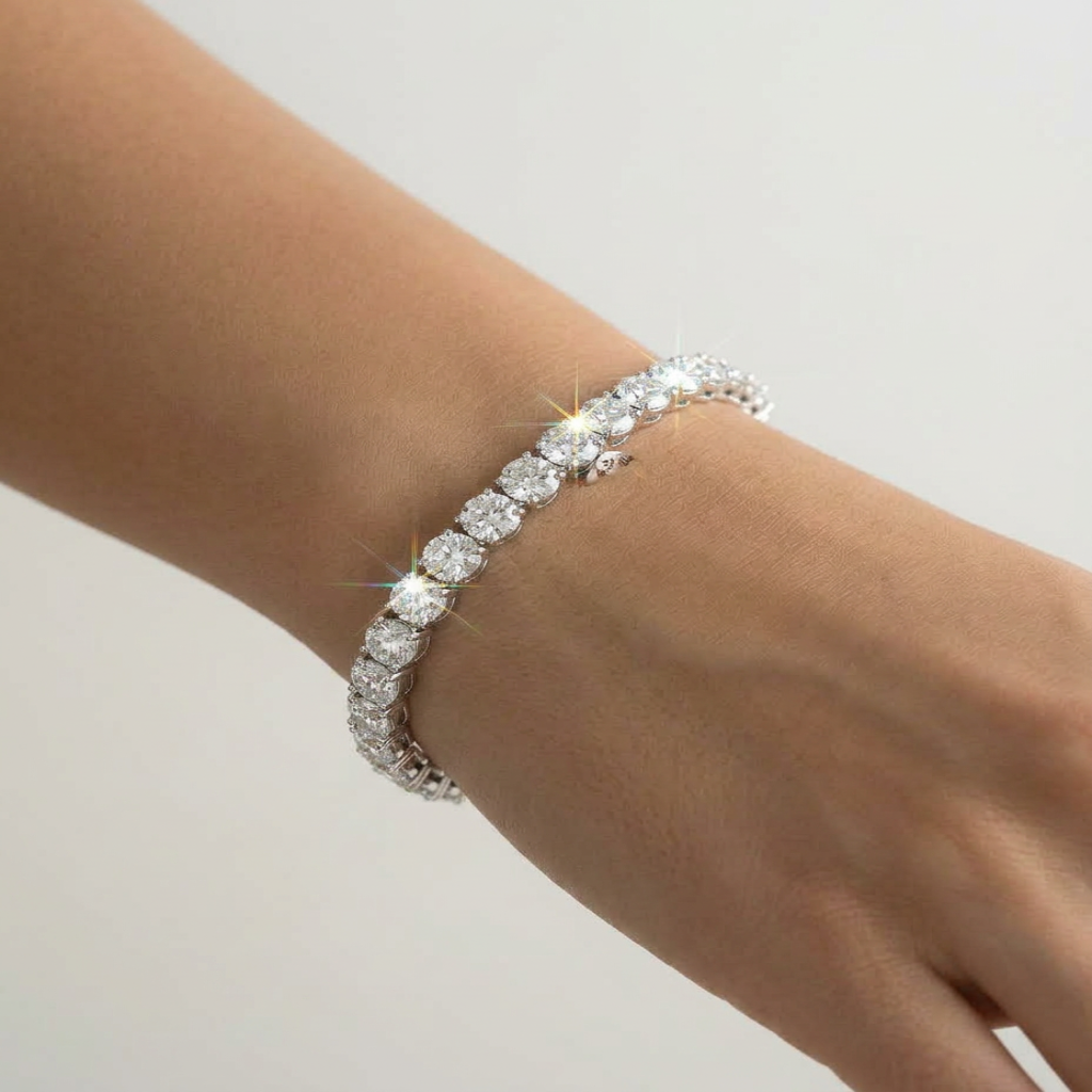 Diamond bracelet on a wrist against a plain background