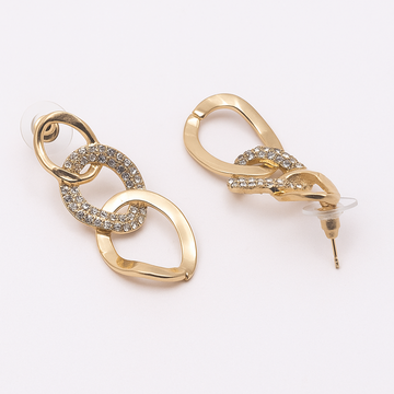 Gold earrings with intricate designs on a white background