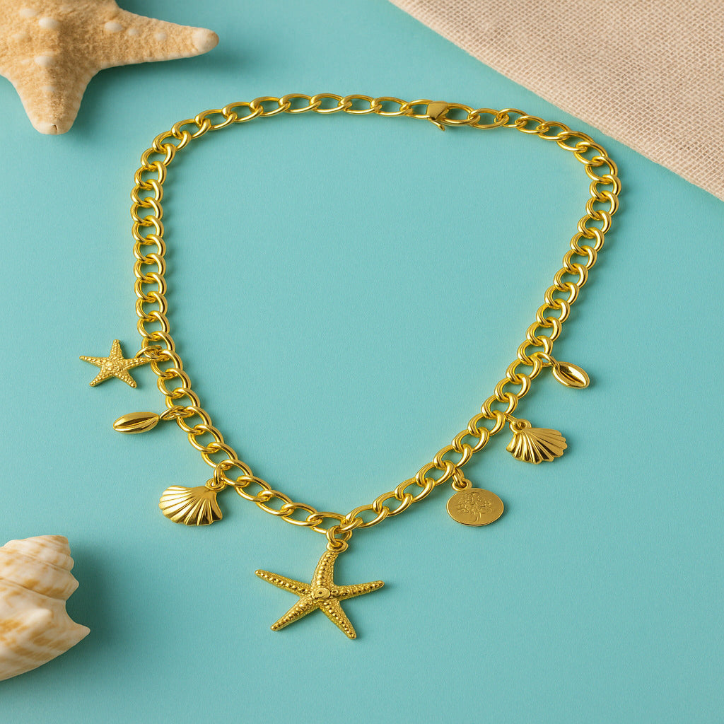Gold chain bracelet with starfish and shell charms on a teal background