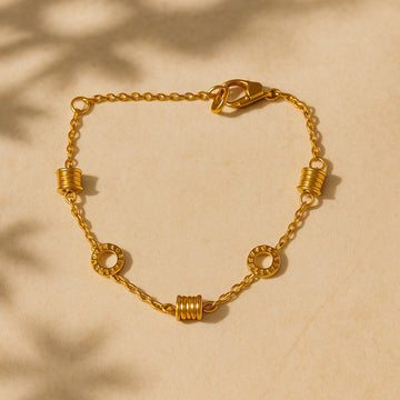 Gold chain bracelet on a beige background