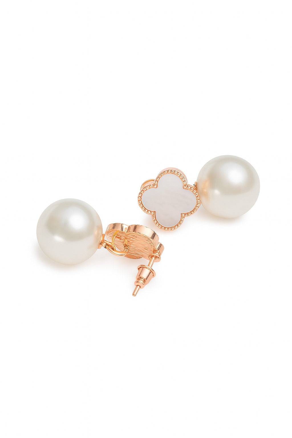 Pearl earrings with rose gold accents on a white background