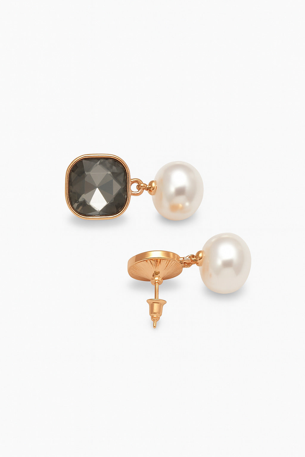 Pair of earrings with pearls and gemstones on a white background