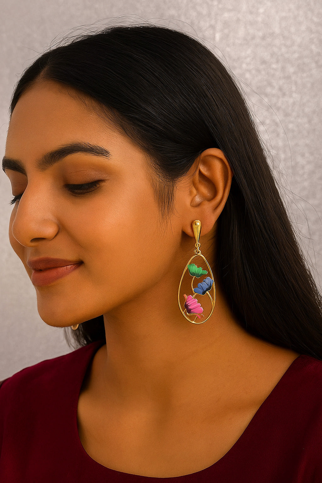 Woman wearing colorful earrings against a neutral background