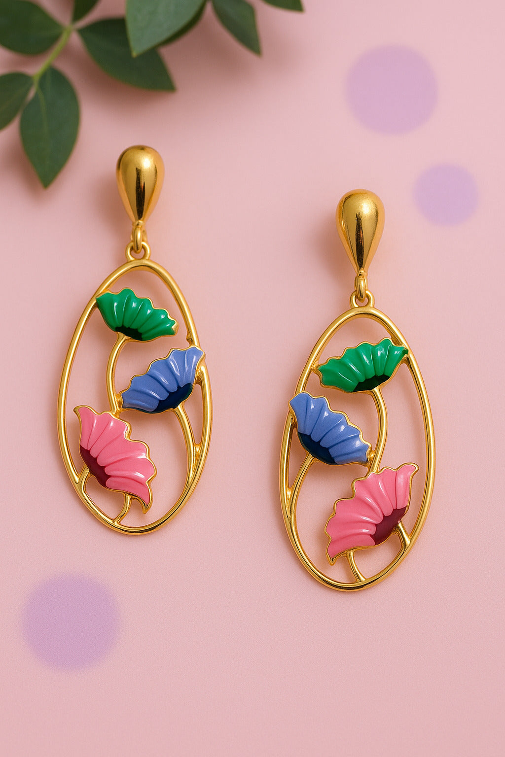 Colorful leaf-shaped earrings on a pink background