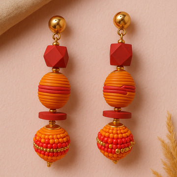 Pair of colorful beaded earrings on a beige background