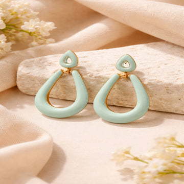 Light blue earrings with gold accents on a beige fabric background
