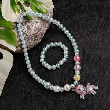 Beaded bracelet with a small animal charm on a dark textured surface