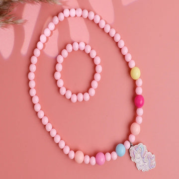A set of plastic pink kids necklace and bracelet jewelry with a cute charm on the necklace, displayed on a pink background.