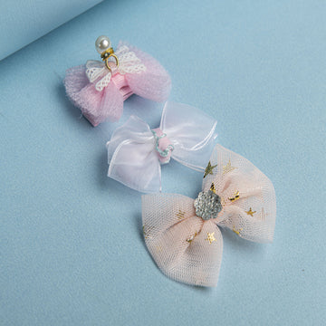 Set of decorative hair bows and scrunchies on a light blue background