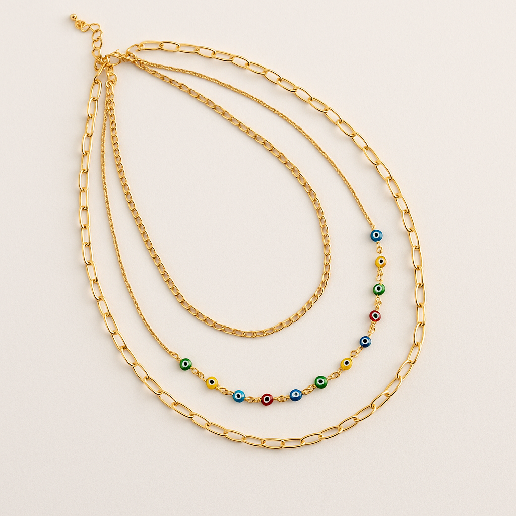 Two gold necklaces on a light beige background