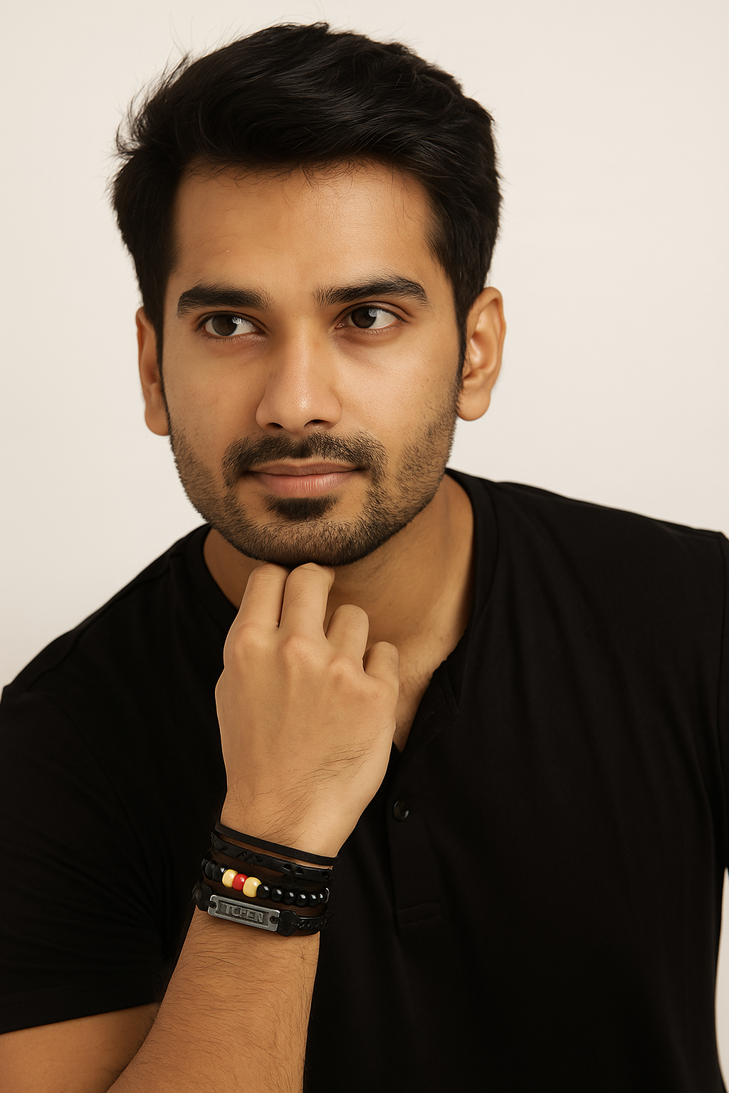 Man wearing a black shirt with a neutral background