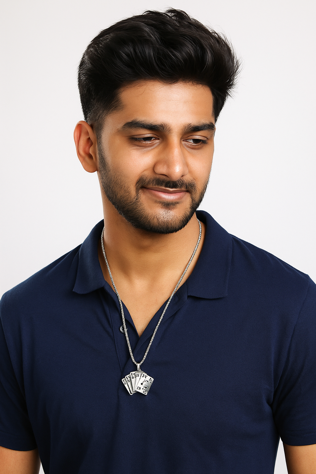 Man wearing a navy blue polo shirt with a necklace on a light gray background