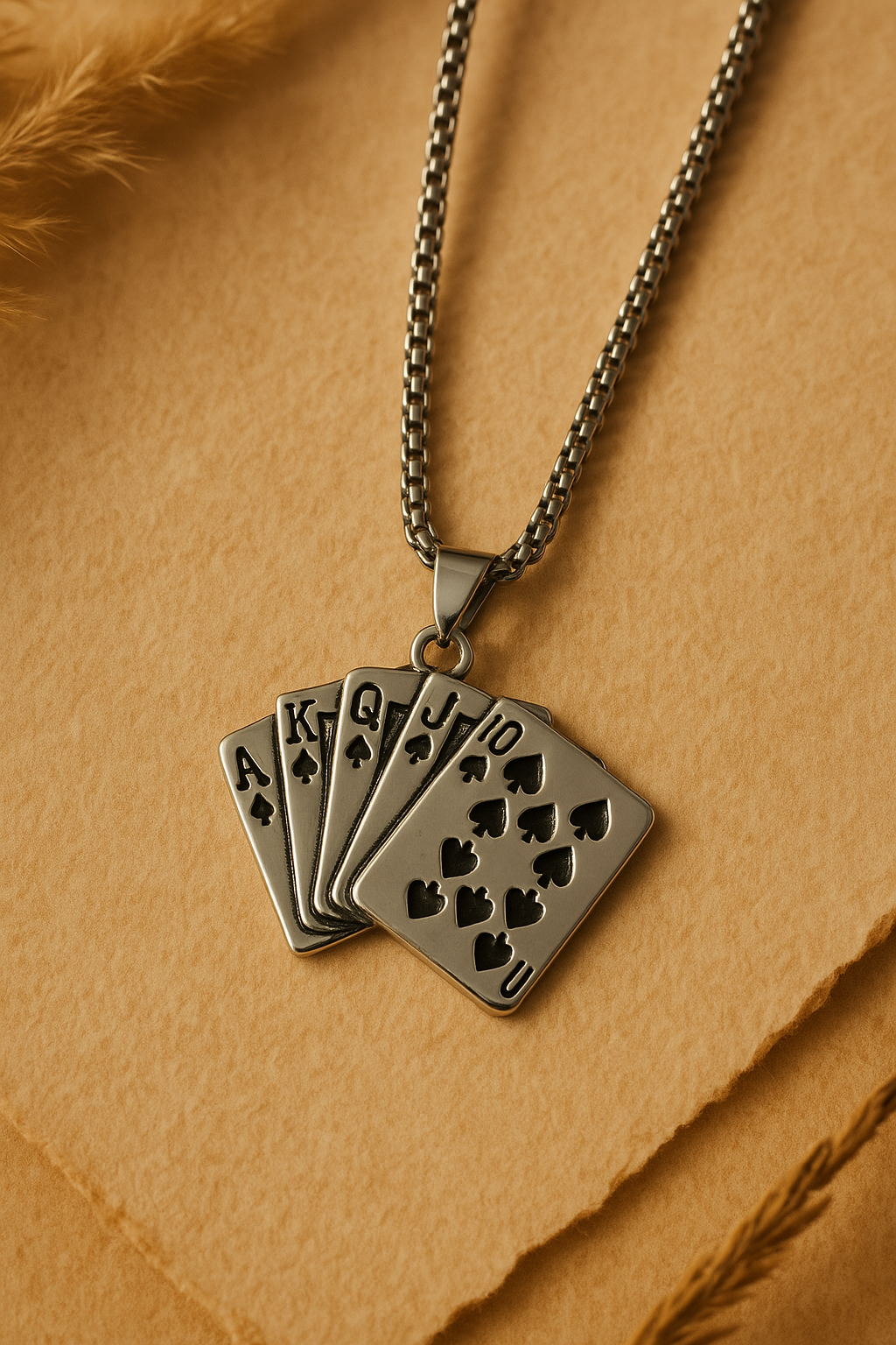 Necklace with a pendant shaped like a set of playing cards on a beige background