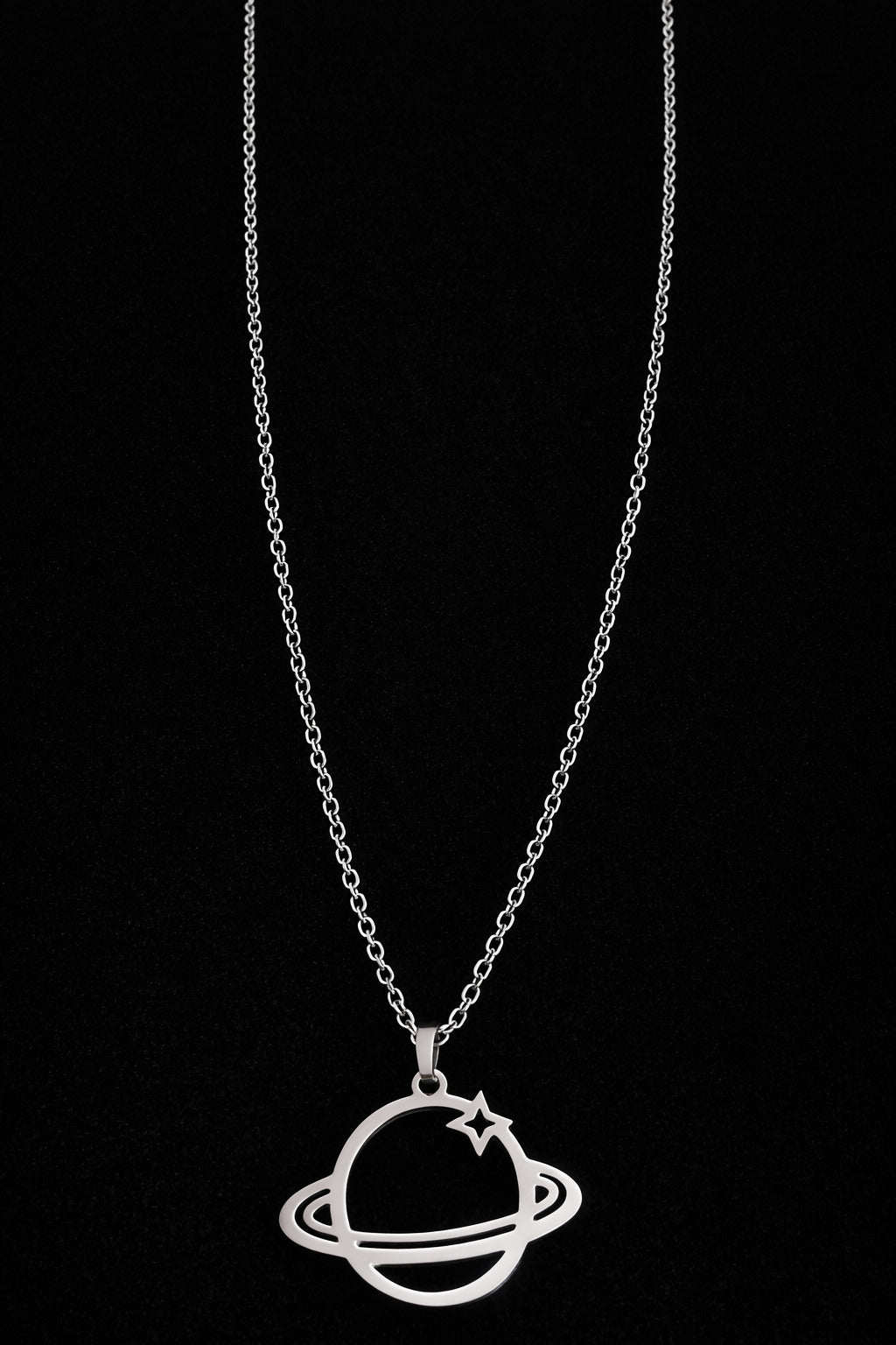 Silver necklace with a planet pendant on a black background