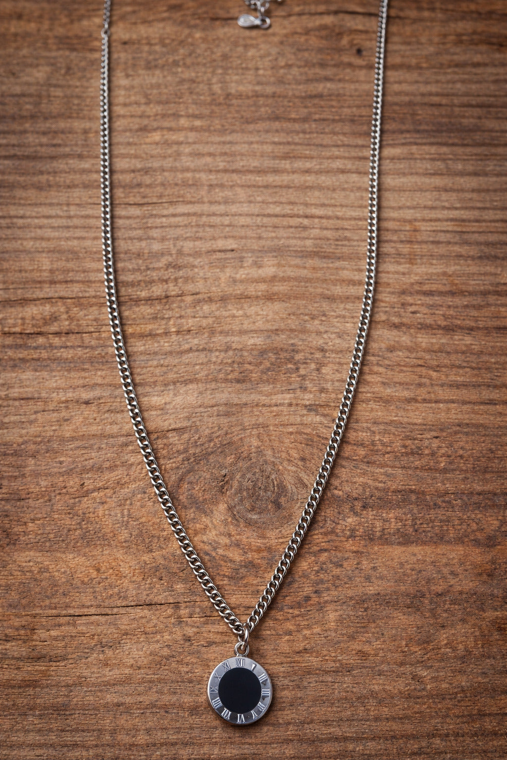 Necklace with a round pendant on a wooden surface