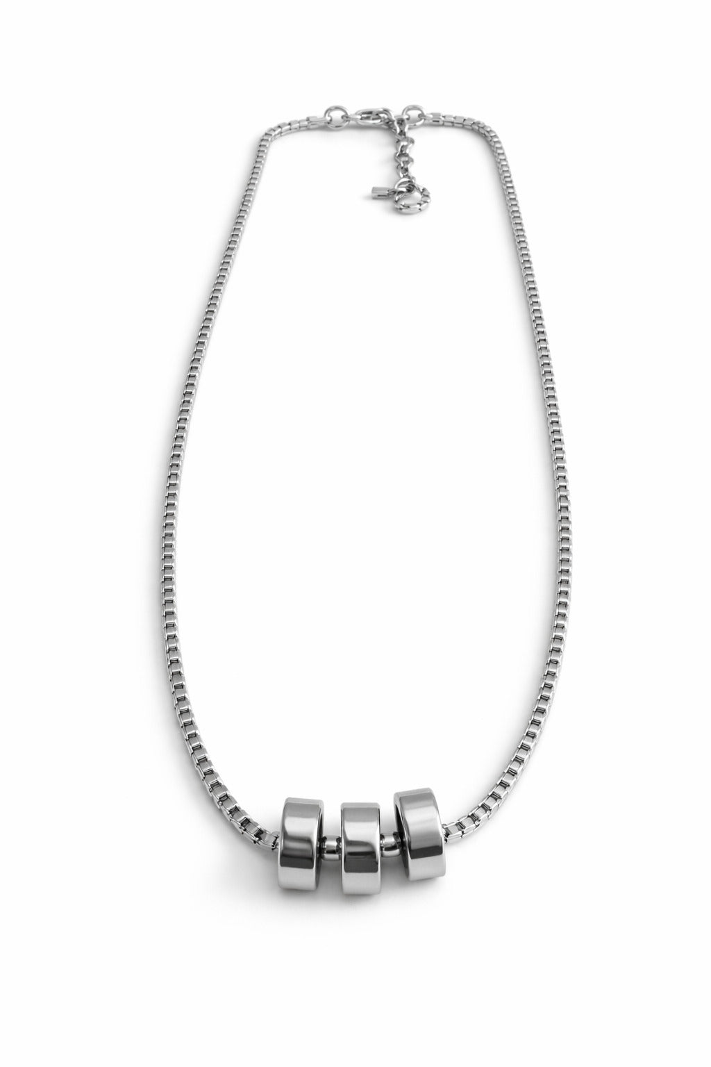 Silver necklace with cylindrical beads on a white background