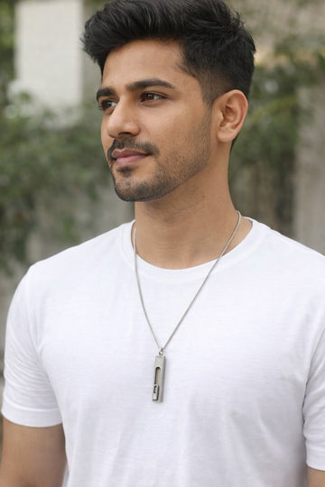Man wearing a white t-shirt with a blurred outdoor background