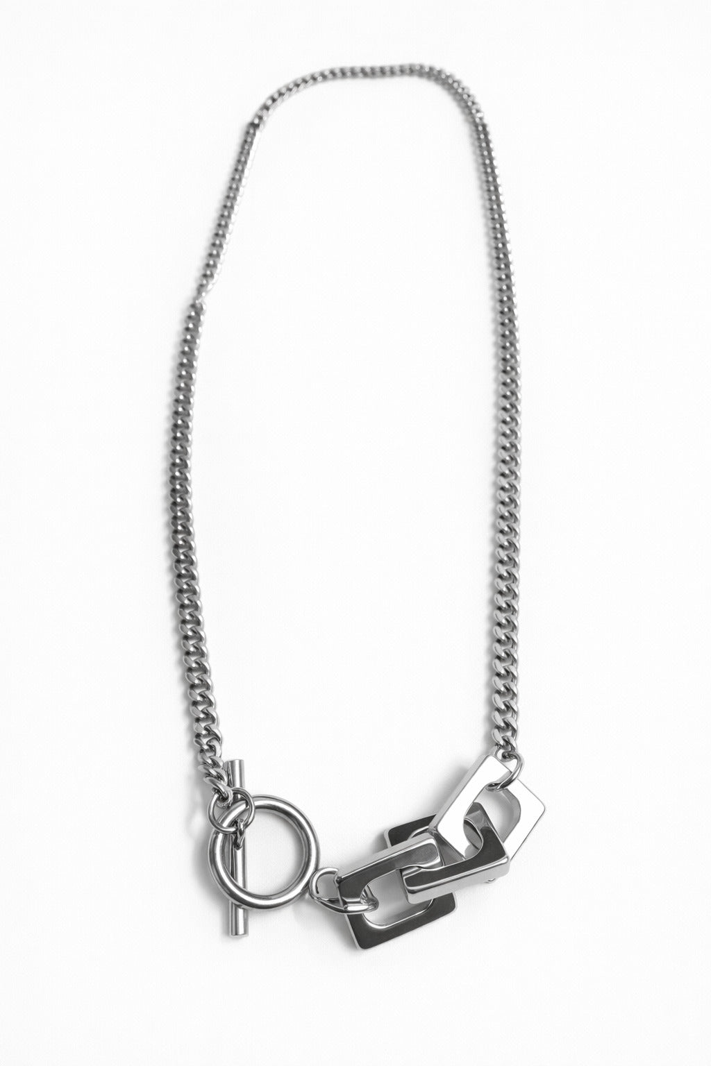 Silver necklace with a chain and pendant on a white background