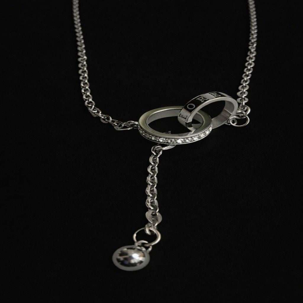 Silver necklace with a unique pendant on a black background