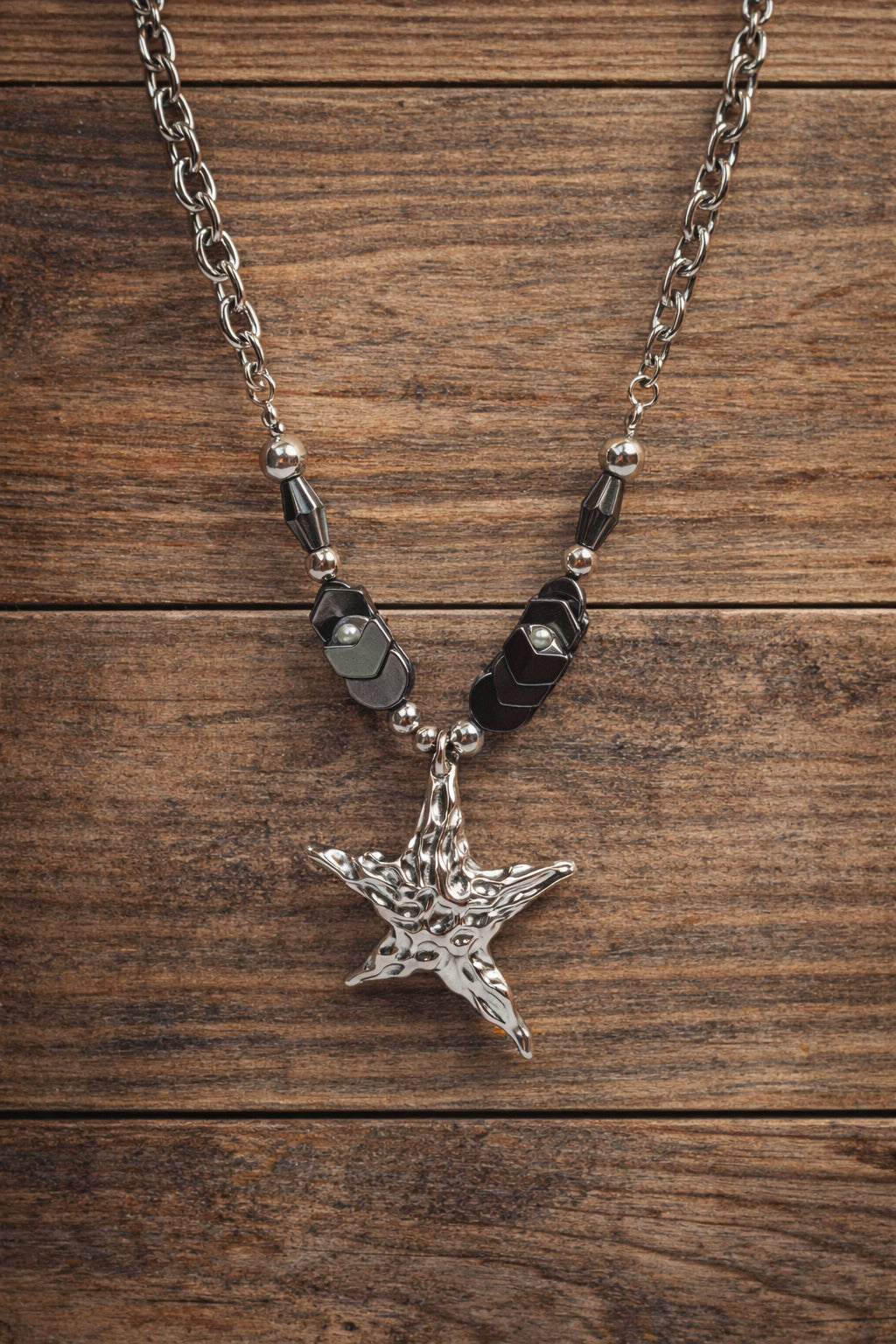 Star-shaped pendant necklace on a wooden surface