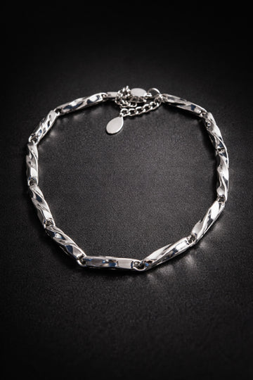 Silver chain bracelet on a black background