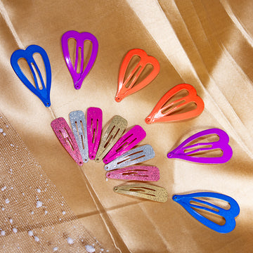 A collection of heart-shaped tic tac hair clips in various colors including blue, red, pink, purple, and silver, displayed on a golden background.