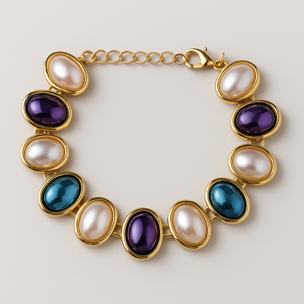Gold bracelet with colorful gemstones on a light background