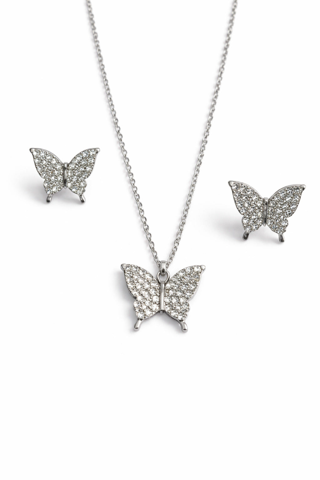 Butterfly-themed jewelry set with necklace, earrings, and pendant on a white background