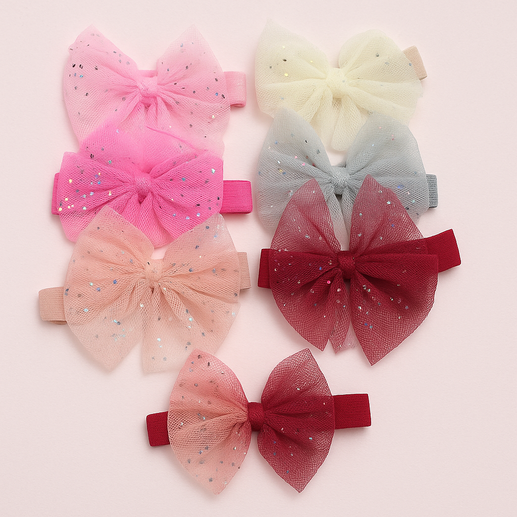 Set of colorful bow hair accessories on a light pink background