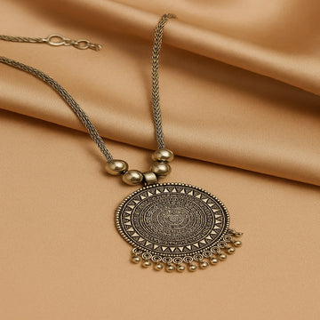 Decorative necklace with a large circular pendant on a beige fabric background