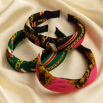 Colorful headbands with chain designs on a beige fabric background