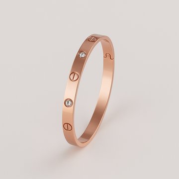 Rose gold bracelet with diamond accents on a light gray background